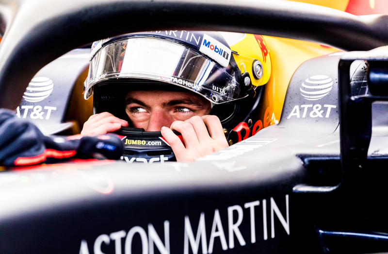 Max Verstappen pulls on his helmet before FP2.